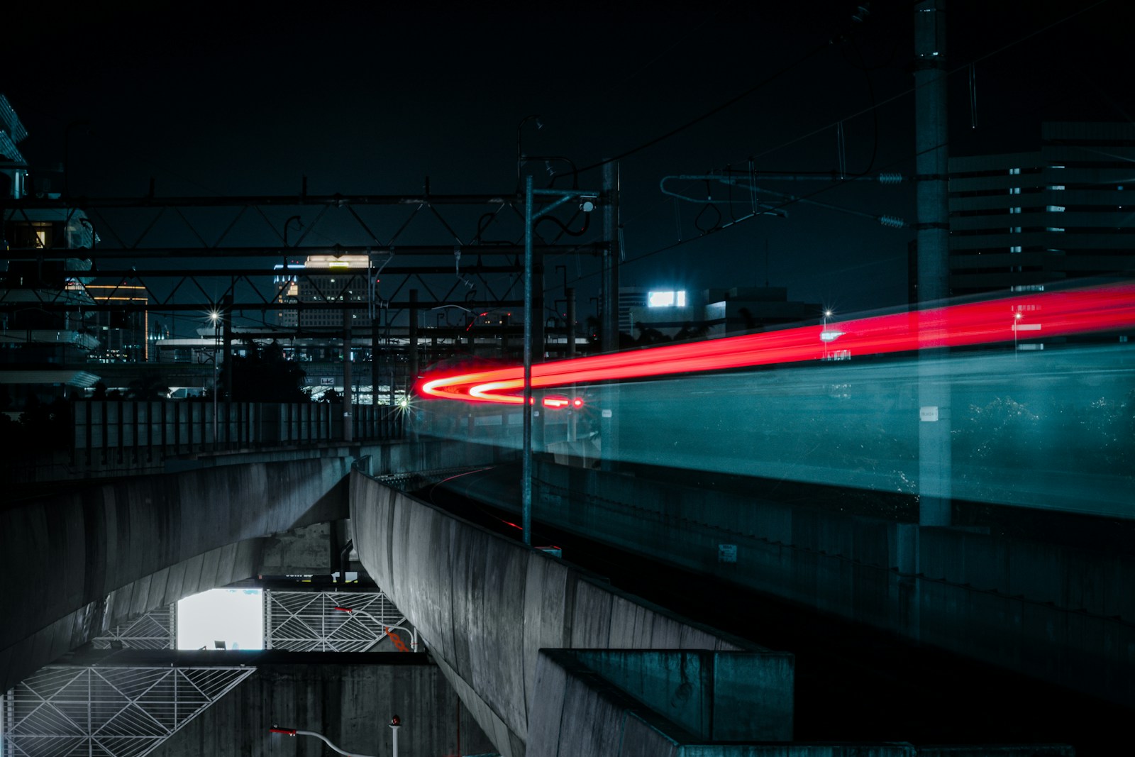 A red light trail on an elevated road at dusk